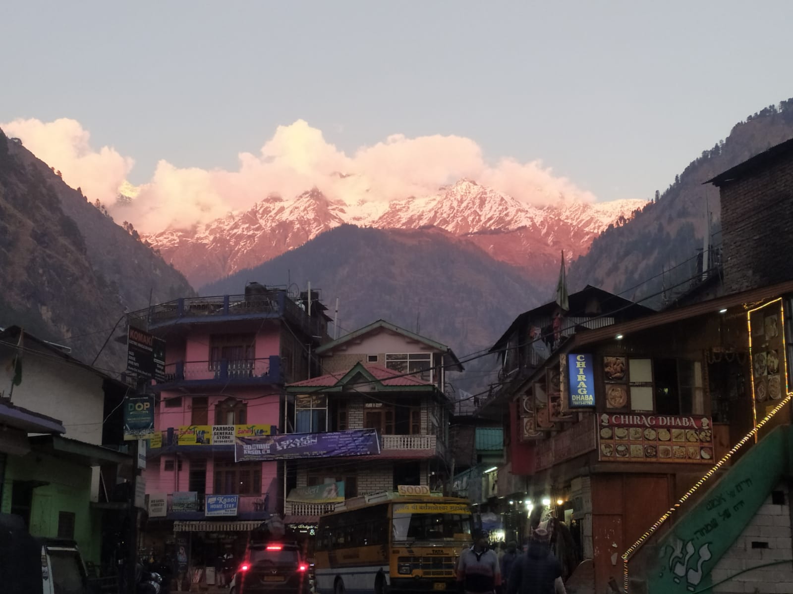Snowy peaks glowing over Kasol town