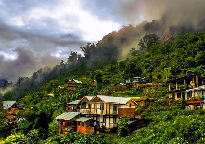 Misty Himalayan village on the slopes